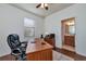 Bright home office with wood desk, two chairs, and access to a full bath at 6814 Willowshire Way, Bradenton, FL 34212