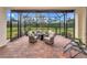 Relaxing screened patio with brick pavers and wicker furniture at 6814 Willowshire Way, Bradenton, FL 34212