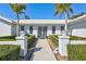 Front entry with walkway, landscaping, and white columns at 6851 Country Lakes Cir, Sarasota, FL 34243