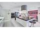 Modern kitchen with large island, stainless steel appliances, and white cabinetry at 6851 Country Lakes Cir, Sarasota, FL 34243