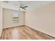 Bedroom with wood-look floors and ceiling fan at 6868 Wild Lake Ter, Bradenton, FL 34212