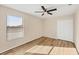 Bedroom with ceiling fan, window blinds, and double doors at 6868 Wild Lake Ter, Bradenton, FL 34212