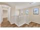 Upstairs hallway with white railing and wood floors at 6868 Wild Lake Ter, Bradenton, FL 34212