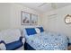 Bedroom with white wicker furniture and blue bedding at 713 Harrington Lake N Dr # 18, Venice, FL 34293