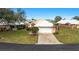 Front view of a villa with attached garage and manicured lawn at 713 Harrington Lake N Dr # 18, Venice, FL 34293