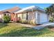 Front view of a light peach house with a white garage door and walkway at 713 Harrington Lake N Dr # 18, Venice, FL 34293