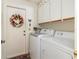 Laundry room with washer, dryer, and ample cabinet space at 713 Harrington Lake N Dr # 18, Venice, FL 34293