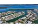 Aerial view of waterfront property with a dock and lush greenery, offering stunning views of the surrounding waterways at 721 Old Compass Rd, Longboat Key, FL 34228