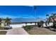 Front view of single-story house with metal roof at 721 Old Compass Rd, Longboat Key, FL 34228