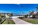 Single-story home with metal roof and paved driveway at 721 Old Compass Rd, Longboat Key, FL 34228