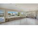 Living room with wall-to-wall windows overlooking canal at 721 Old Compass Rd, Longboat Key, FL 34228