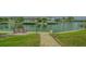 Inviting waterfront view with brick-paved path leading to a serene canal at 721 Old Compass Rd, Longboat Key, FL 34228