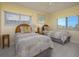 Cozy bedroom with two twin beds, natural light, and neutral decor at 757 Beach Rd # 300, Sarasota, FL 34242