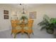 Dining area with a glass-top table, wicker chairs, and a tropical plant at 757 Beach Rd # 300, Sarasota, FL 34242