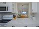 Bright kitchen with white cabinets and countertops, modern appliances and an open layout at 757 Beach Rd # 300, Sarasota, FL 34242