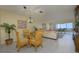 Inviting living room featuring a glass table, seating, and sliding glass door to outdoor balcony with ocean views at 757 Beach Rd # 300, Sarasota, FL 34242