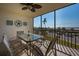 Breezy screened-in patio with a glass-top table and seating to enjoy the ocean views at 757 Beach Rd # 300, Sarasota, FL 34242