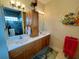 Double vanity bathroom with a large mirror and ocean decor at 7619 Teal Trace, Bradenton, FL 34203