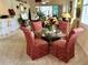 Elegant dining room features a glass-top table with four chairs at 7619 Teal Trace, Bradenton, FL 34203