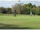 Driving range with two golfers practicing at 7619 Teal Trace, Bradenton, FL 34203