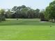 Green golf course with a golf cart at 7619 Teal Trace, Bradenton, FL 34203