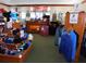 A vibrant golf shop interior, filled with a variety of merchandise, displays, and staffed counter at 7619 Teal Trace, Bradenton, FL 34203