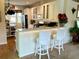 Kitchen with breakfast bar and white barstools at 7619 Teal Trace, Bradenton, FL 34203