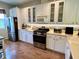 Bright kitchen with stainless steel appliances and white cabinets at 7619 Teal Trace, Bradenton, FL 34203