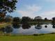 Serene lake view with tree reflections at 7619 Teal Trace, Bradenton, FL 34203