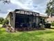 Well-maintained screened patio with landscaping at 7619 Teal Trace, Bradenton, FL 34203