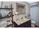 Updated bathroom features a vanity with marble top, shelving, and a shower/tub combo at 796 Capri Isles Blvd # 241, Venice, FL 34292