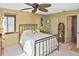 Bedroom with a full-size bed, dresser, and a window with window coverings at 796 Capri Isles Blvd # 241, Venice, FL 34292