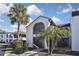 Attractive condo building with palm trees and walkway at 796 Capri Isles Blvd # 241, Venice, FL 34292