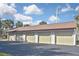 Four-car garage with attached carport offers ample parking and storage at 796 Capri Isles Blvd # 241, Venice, FL 34292