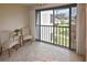 Open balcony with seating that provides green space views of the community at 796 Capri Isles Blvd # 242, Venice, FL 34292