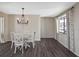 Cozy dining area features chandelier lighting and a large window, creating a welcoming space at 796 Capri Isles Blvd # 242, Venice, FL 34292