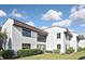 Exterior view of a condo building with well-kept landscaping, showcasing the residential charm at 796 Capri Isles Blvd # 242, Venice, FL 34292