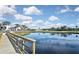 Scenic view of community pond with golf course in the background and blue skies at 796 Capri Isles Blvd # 242, Venice, FL 34292