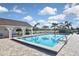 Refreshing pool with a covered lounge area overlooking manicured grounds and palm trees at 796 Capri Isles Blvd # 242, Venice, FL 34292