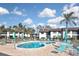 Inviting kidney-shaped pool surrounded by lounge chairs and lush landscaping at 796 Capri Isles Blvd # 242, Venice, FL 34292