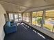 Sun-filled Florida room with a blue couch and carpet at 808 53Rd E Ave # 9, Bradenton, FL 34203