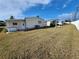 View of multiple mobile homes from the back, showing a large yard at 808 53Rd E Ave # 9, Bradenton, FL 34203