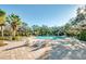 Relaxing community pool with lounge chairs and palm trees at 8501 Starlight Loop, Parrish, FL 34219