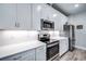 Modern kitchen with white cabinets and stainless steel appliances at 8501 Starlight Loop, Parrish, FL 34219