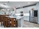 Modern kitchen with white cabinets, quartz countertops, and stainless steel appliances at 8501 Starlight Loop, Parrish, FL 34219