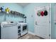 Laundry room with washer, dryer, and storage shelves at 8501 Starlight Loop, Parrish, FL 34219