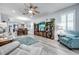 Bright and airy living room with a large sectional sofa and built-in shelving at 8501 Starlight Loop, Parrish, FL 34219