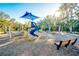 Community playground with playset, swings, and shaded seating at 8501 Starlight Loop, Parrish, FL 34219