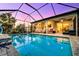 Stunning screened-in pool with view of the home's interior at 8501 Starlight Loop, Parrish, FL 34219