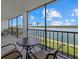 Relaxing balcony with water views and patio furniture at 9393 Midnight Pass Rd # 302, Sarasota, FL 34242